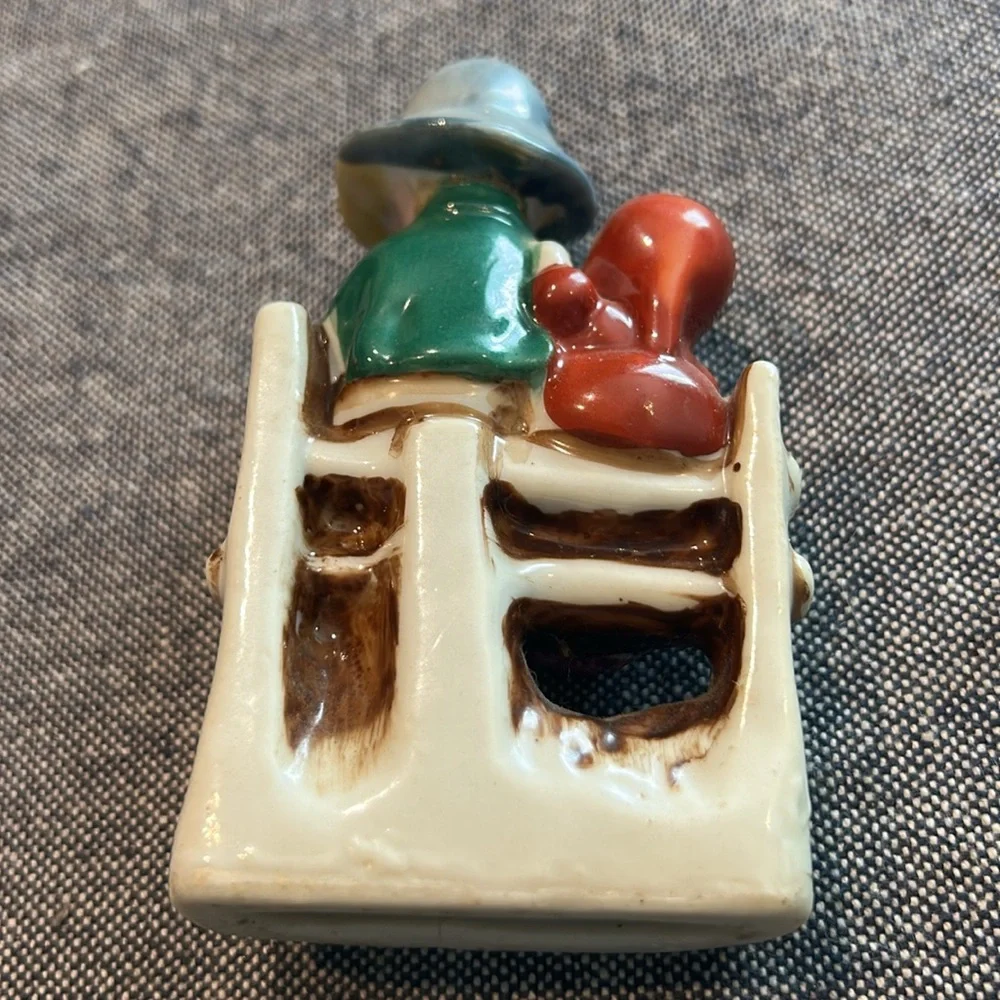 Porcelain Girl and Boy sitting on a bench playing a horn-occupied Japan